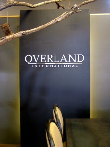Overland International's logo is prominently displayed in the conference area of this open-plan office space.